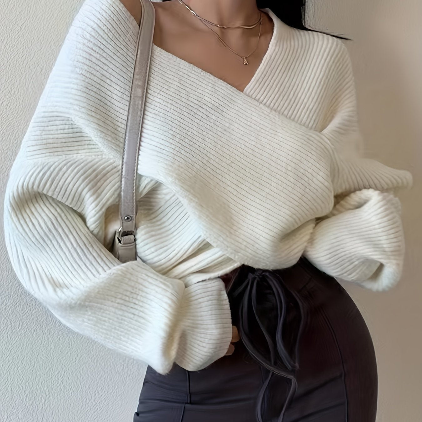 Solid color knitted sweater with a crossed front