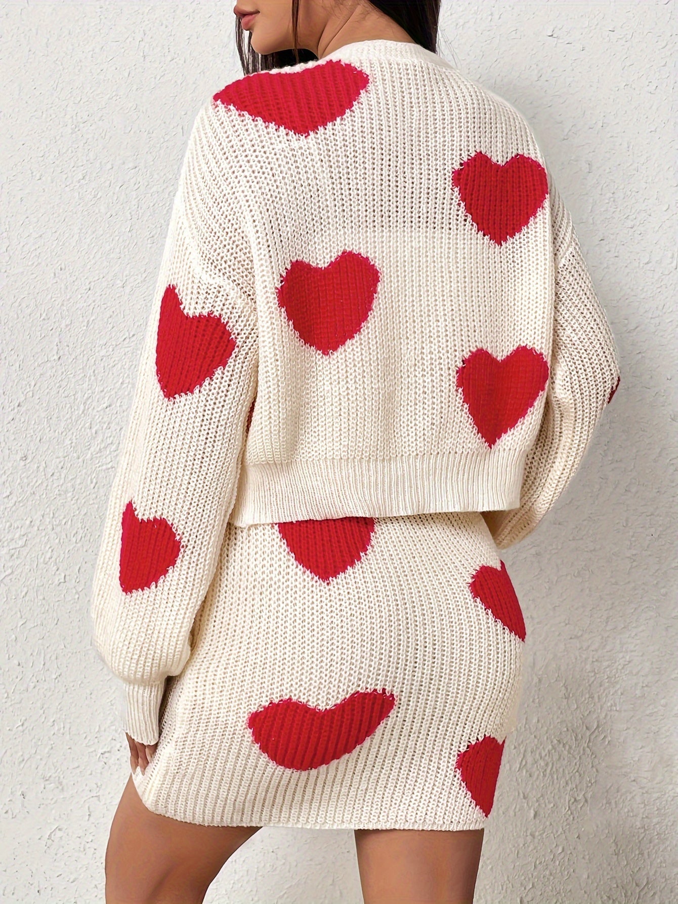 Set consisting of a cardigan with long sleeves and a knitted skirt with a heart pattern