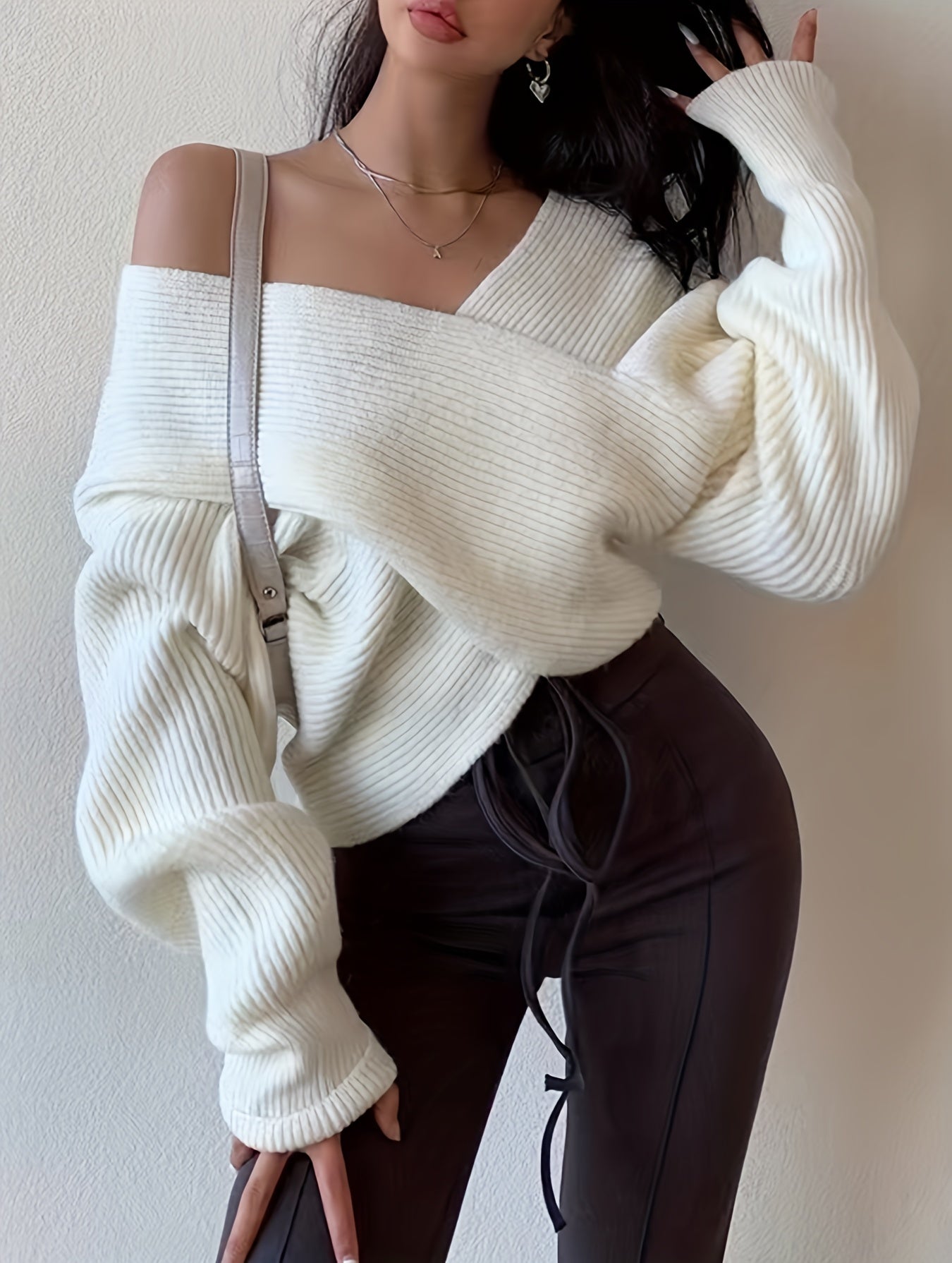 Solid color knitted sweater with a crossed front