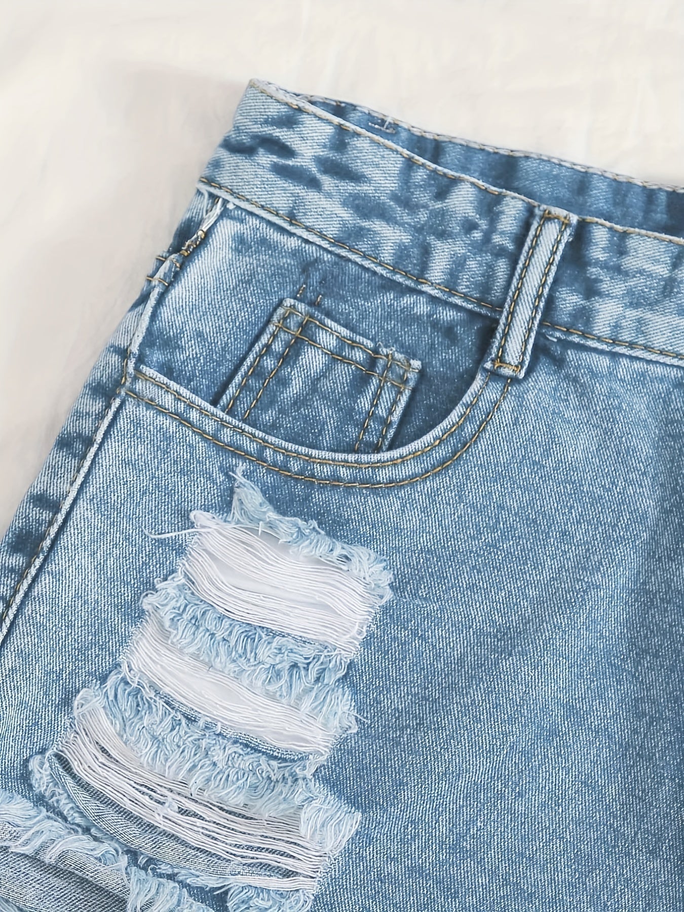 Sky blue denim shorts with frayed hem and tears