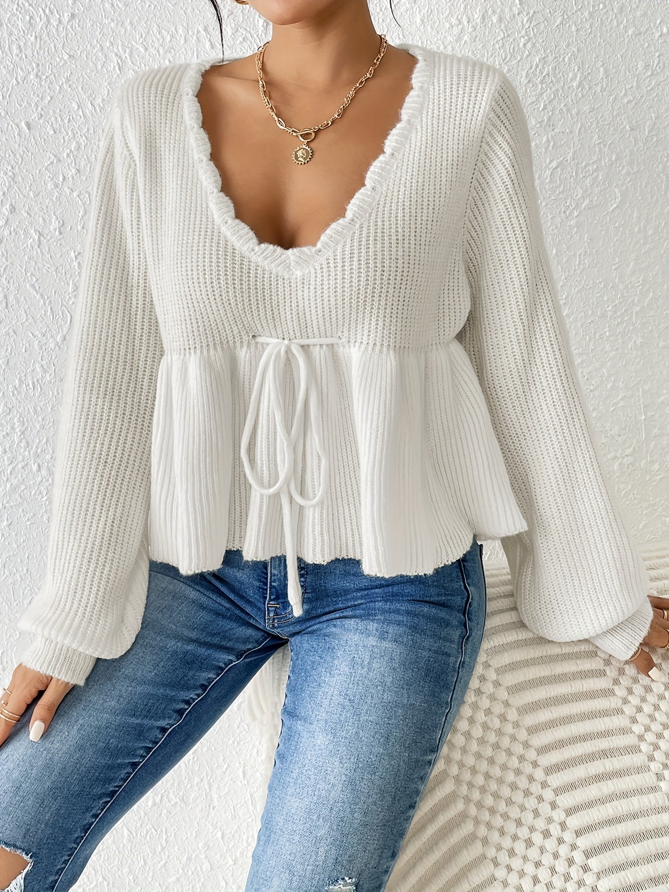 White sweater with drawstring ruffles at the hem