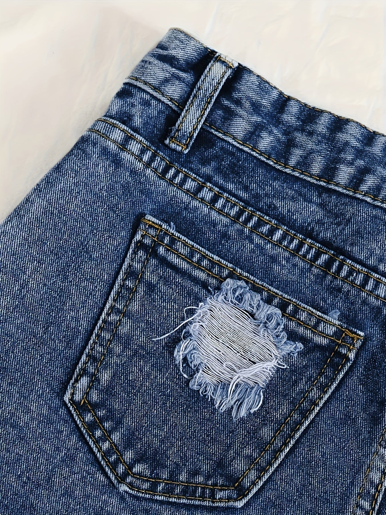 Sky blue denim shorts with frayed hem and tears