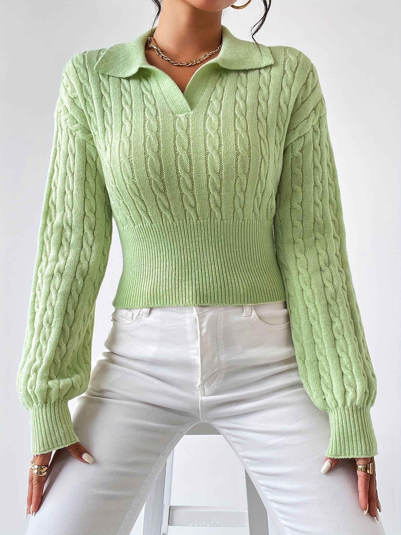 Knitted sweater with a twisted structured V-neck