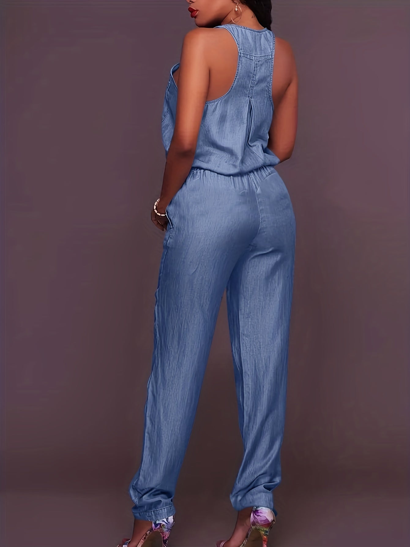 Denim jumpsuit with zipper at the front and waistband