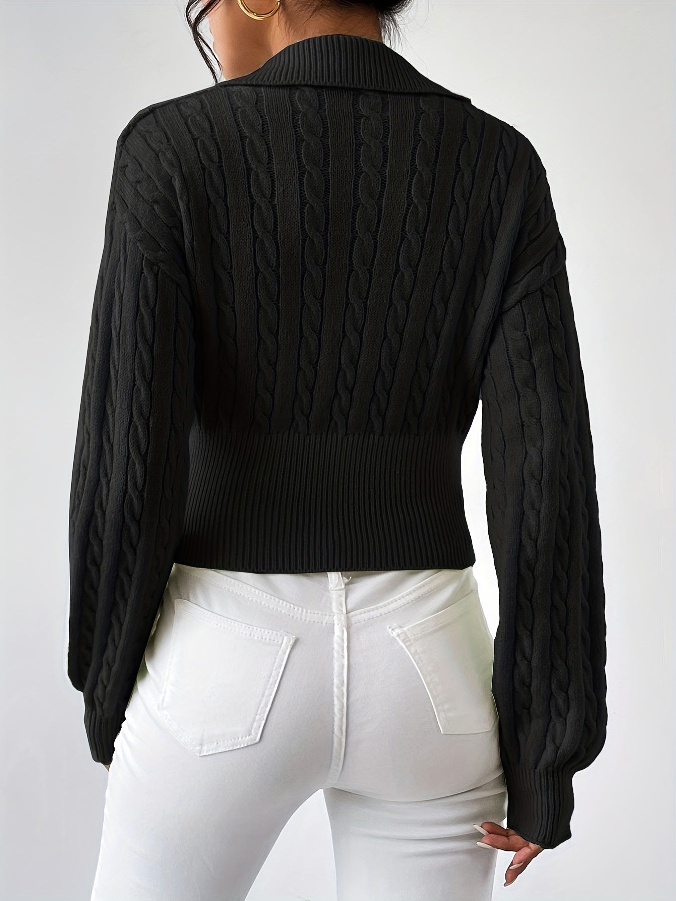 Knitted sweater with a twisted structured V-neck