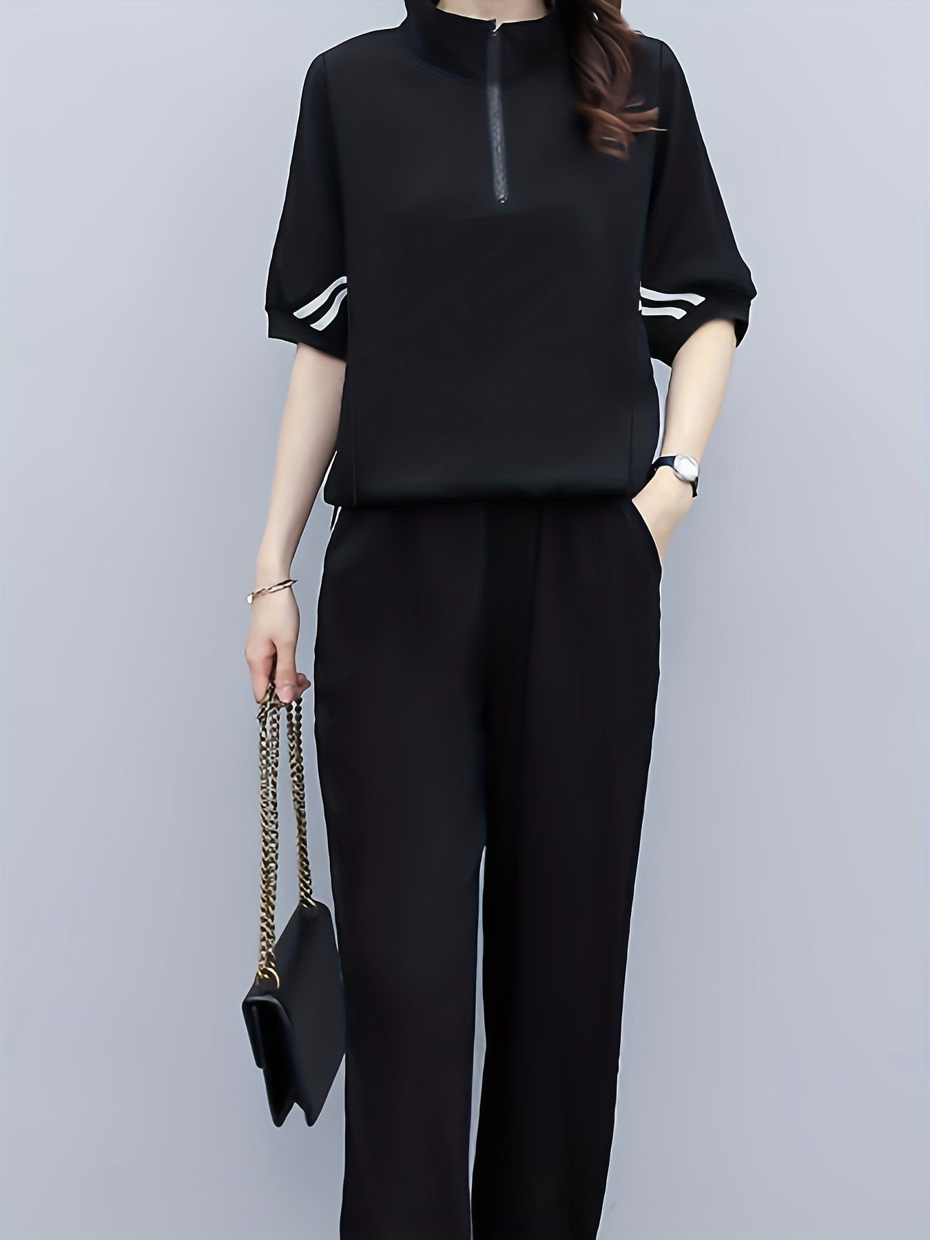 Set consisting of a black T-shirt with half sleeves and high-waisted trousers