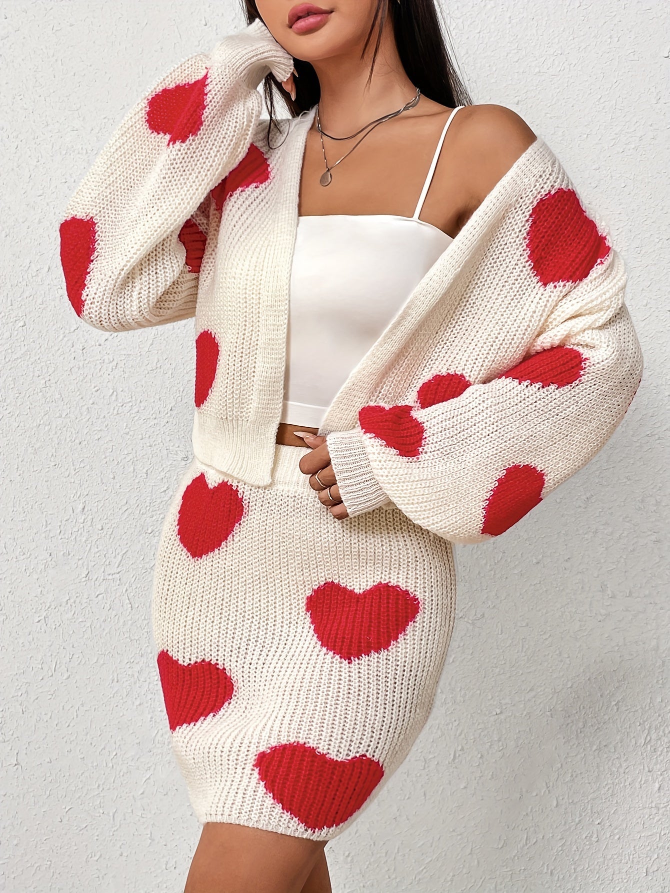 Set consisting of a cardigan with long sleeves and a knitted skirt with a heart pattern