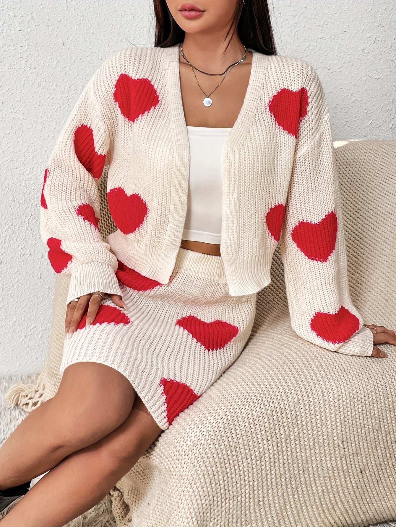 Set consisting of a cardigan with long sleeves and a knitted skirt with a heart pattern