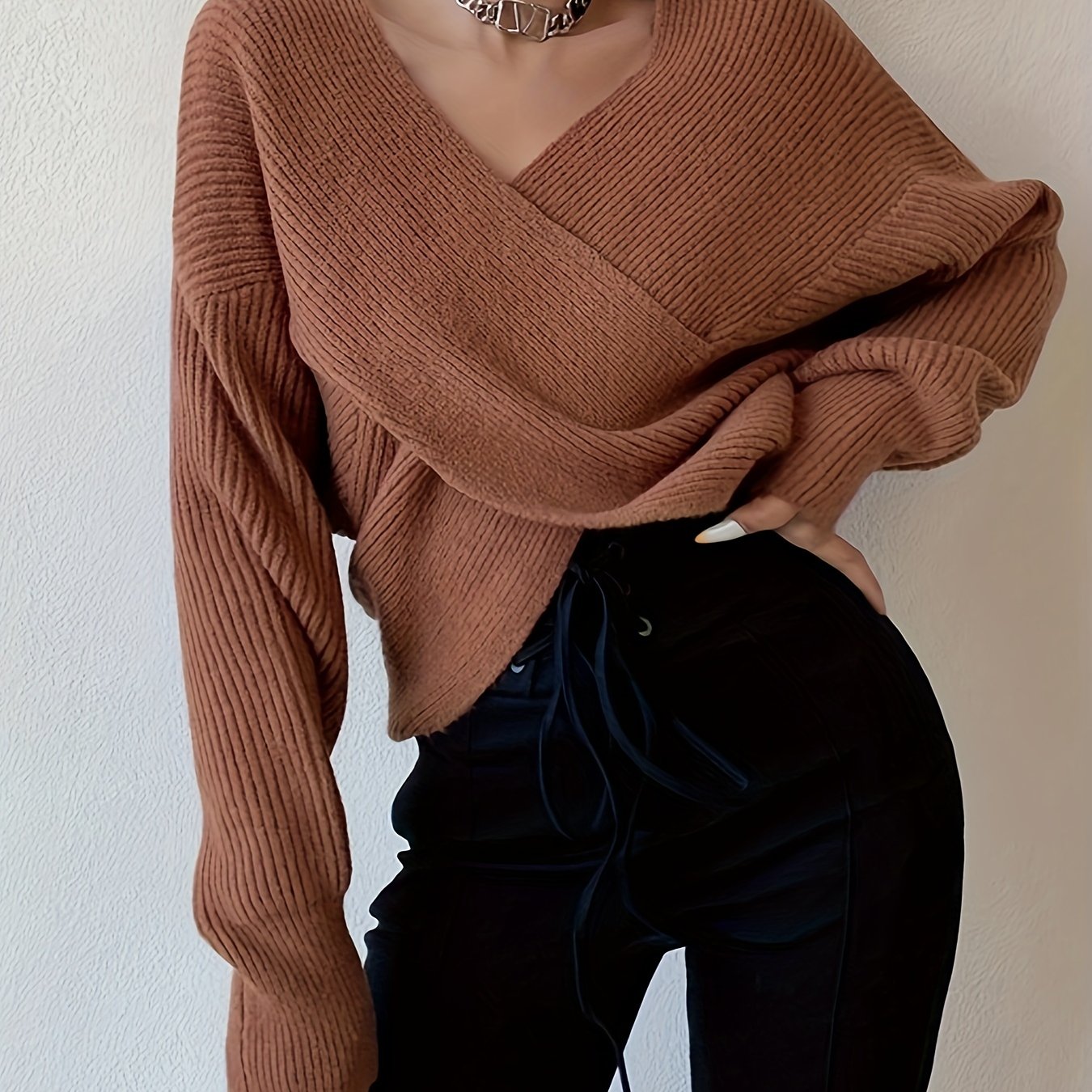 Solid color knitted sweater with a crossed front