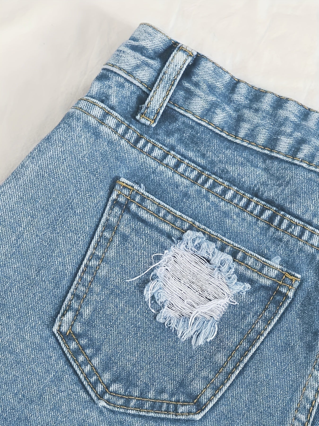 Sky blue denim shorts with frayed hem and tears