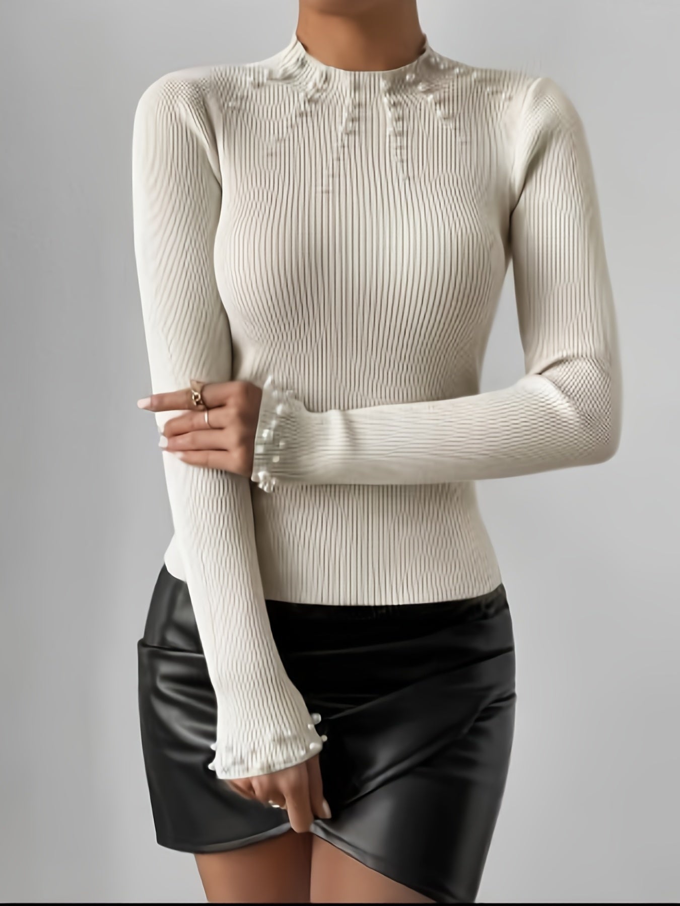 Sweater with high collar and pearl decoration