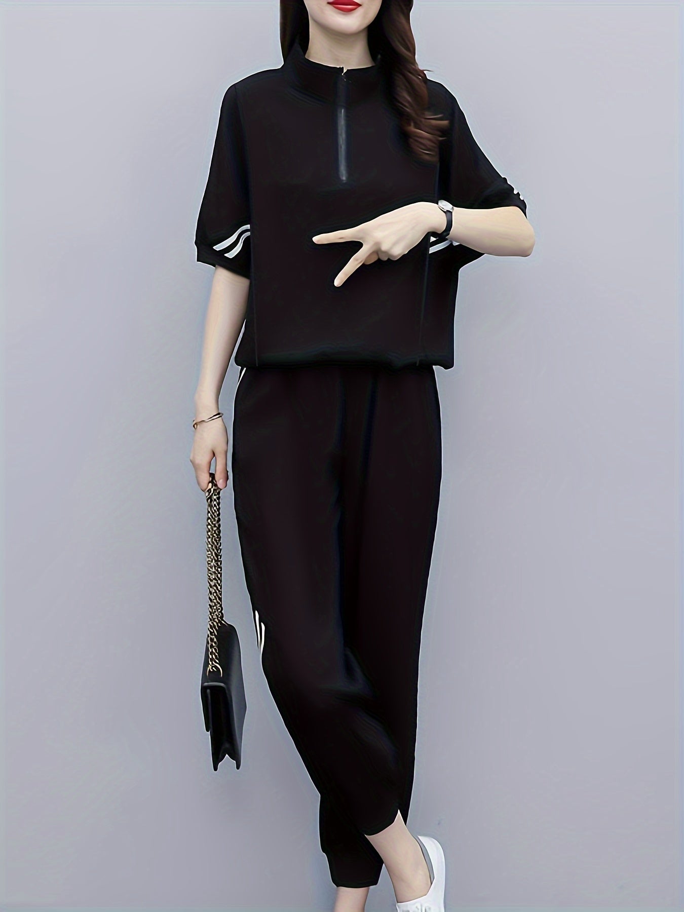 Set consisting of a black T-shirt with half sleeves and high-waisted trousers