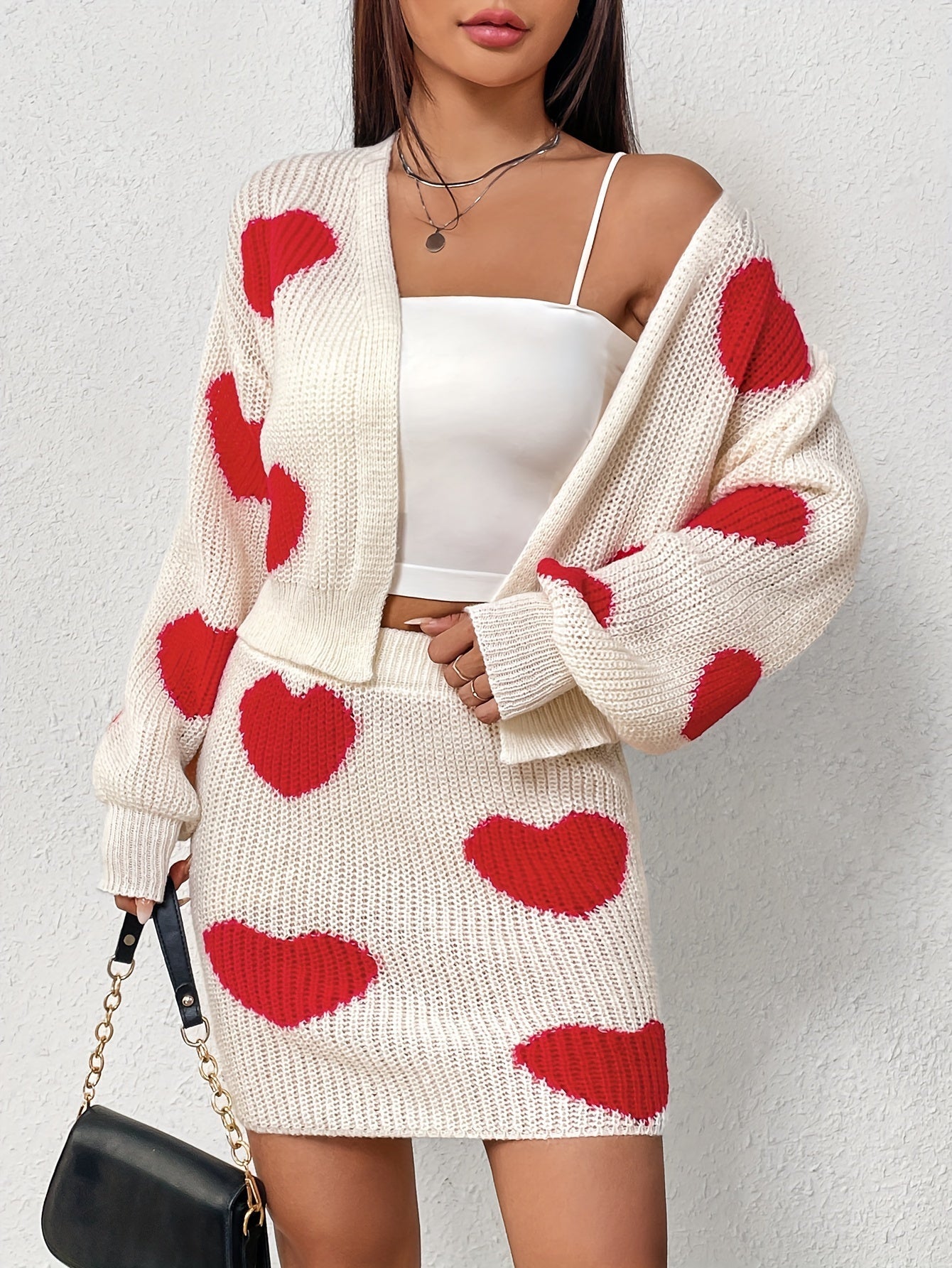 Set consisting of a cardigan with long sleeves and a knitted skirt with a heart pattern