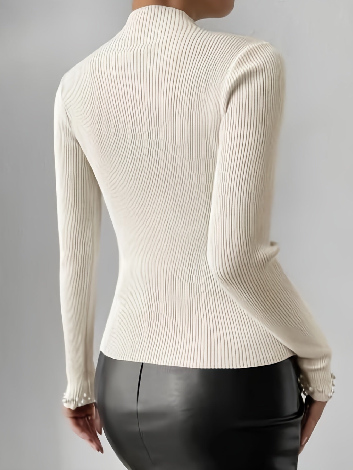 Sweater with high collar and pearl decoration