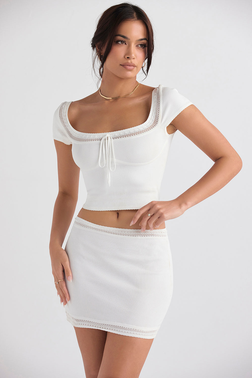 Ivory colored elegant rib knitted top with mini skirt