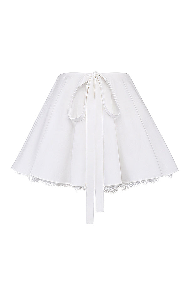 White top with puff sleeves and mini skirt with bow