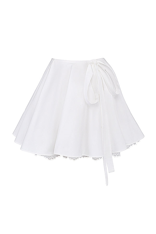 White top with puff sleeves and mini skirt with bow