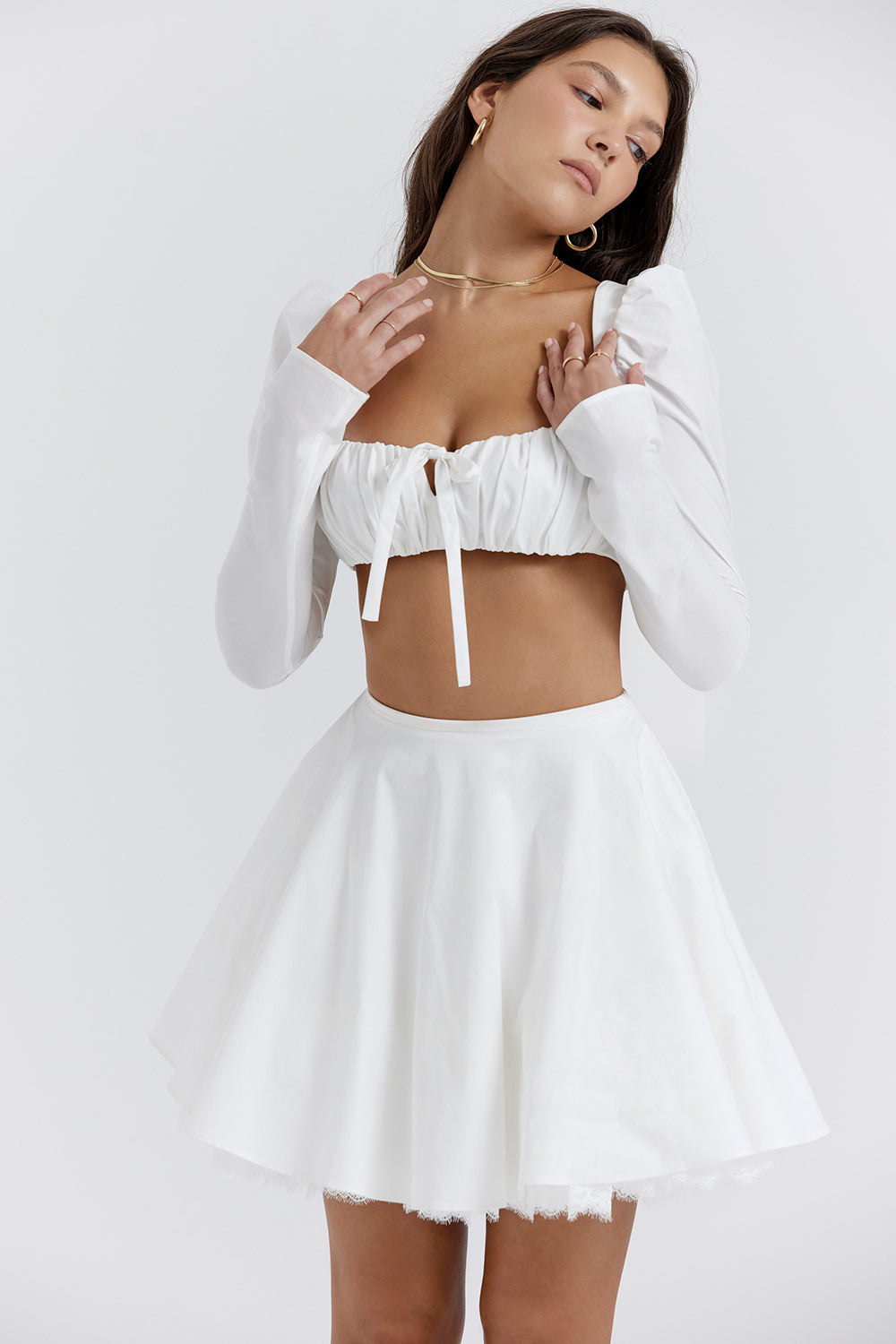 White top with puff sleeves and mini skirt with bow