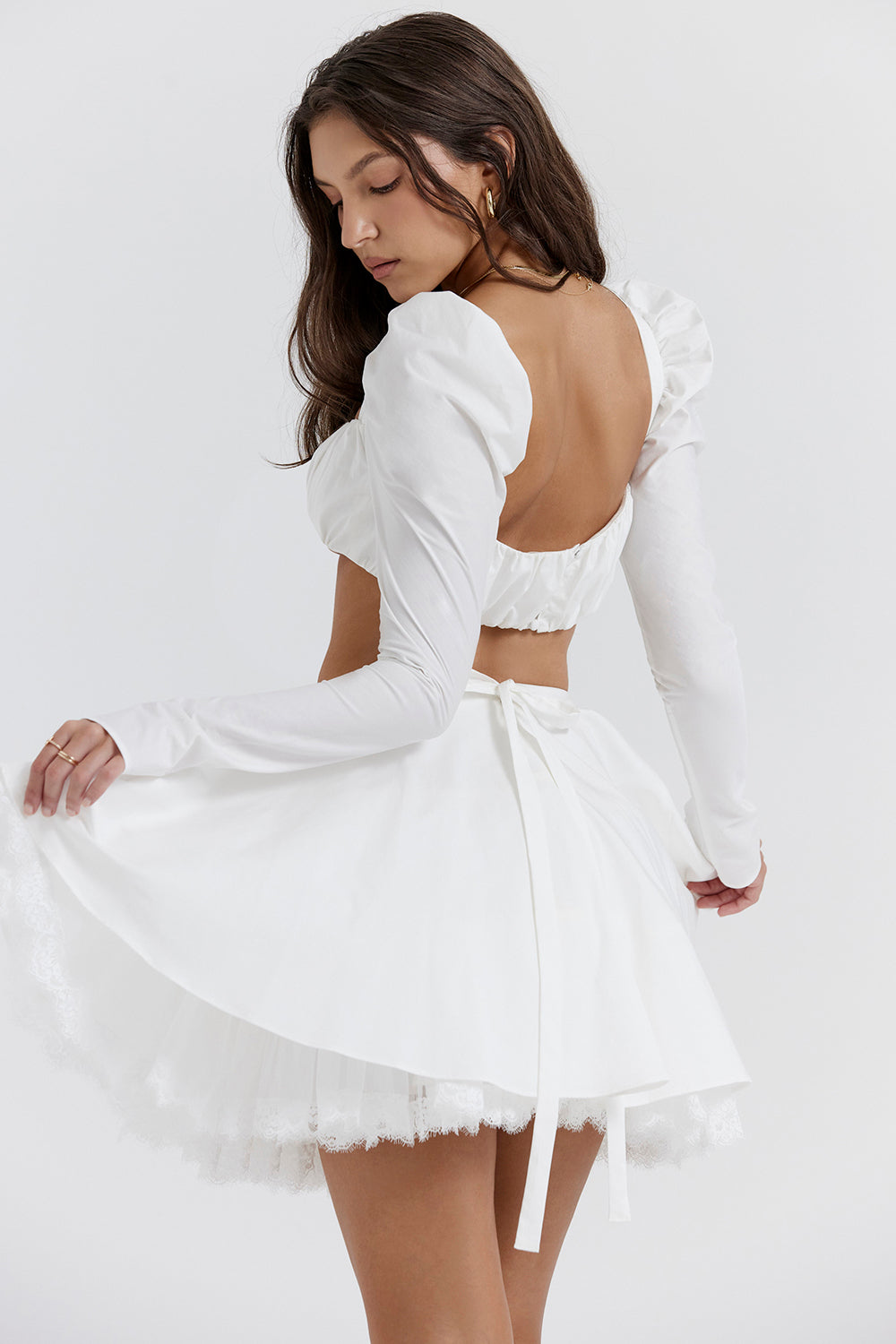 White top with puff sleeves and mini skirt with bow