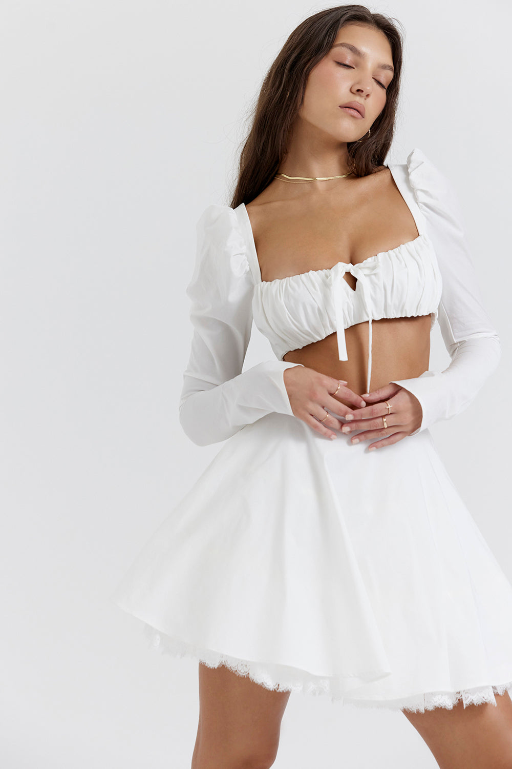 White top with puff sleeves and mini skirt with bow