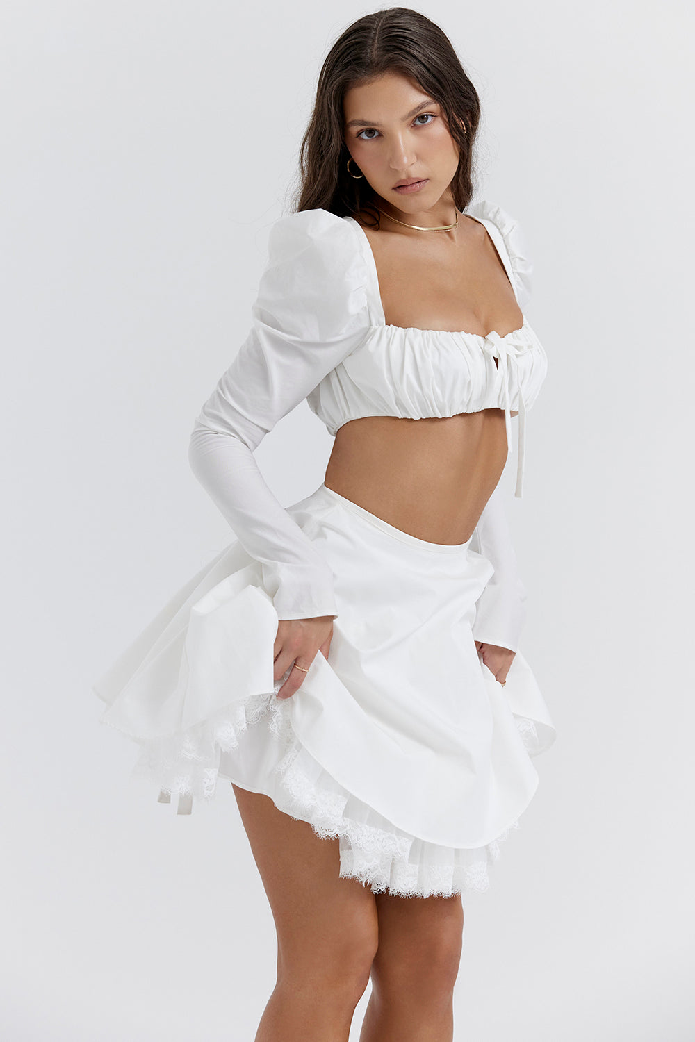 White top with puff sleeves and mini skirt with bow