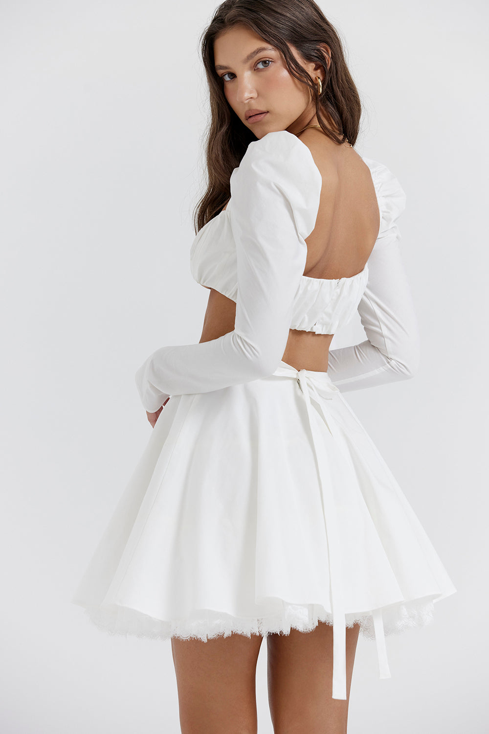 White top with puff sleeves and mini skirt with bow