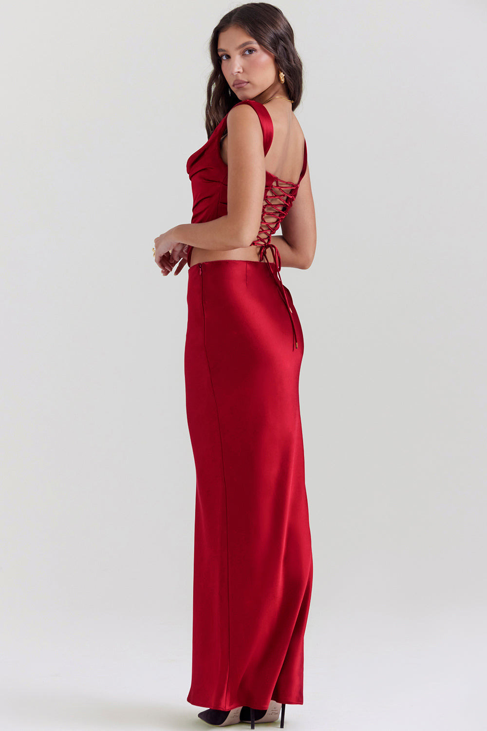 Set of ruby red corset with lace back and diagonally cut satin maxi skirt