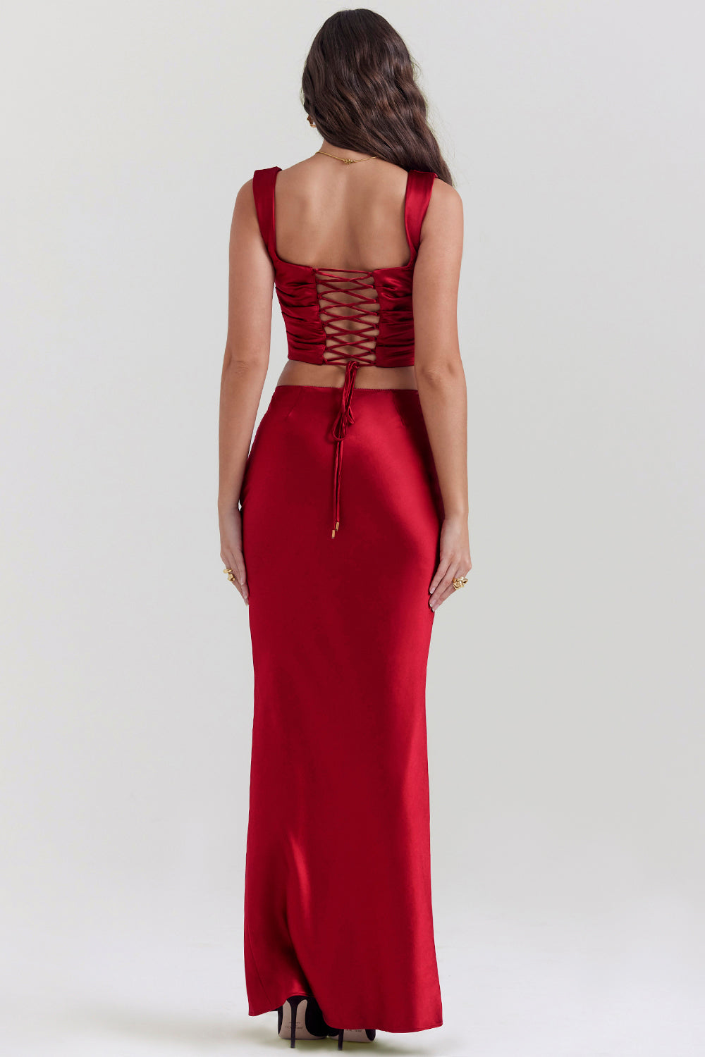 Set of ruby red corset with lace back and diagonally cut satin maxi skirt